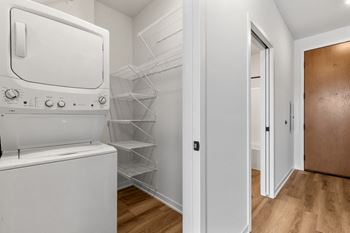 a laundry room with a washer and dryer and a closet